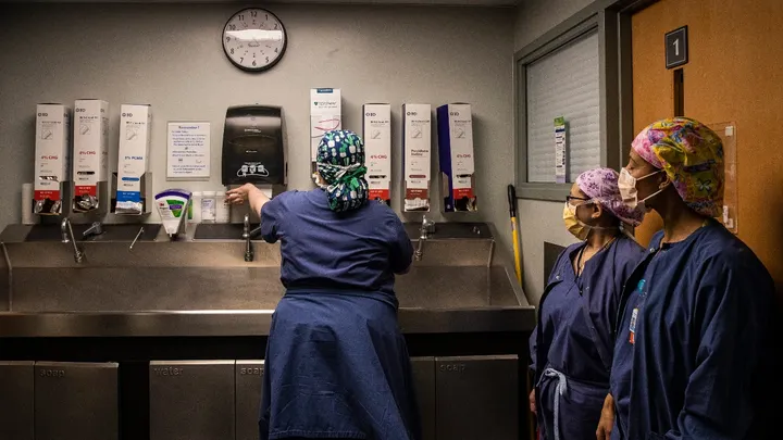 Surgical techs at Newton-Wellesley Hospital washing their hands.
