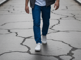 The Inflation Generation’s Playbook for Money and Power Young person navigating cracked city sidewalk.